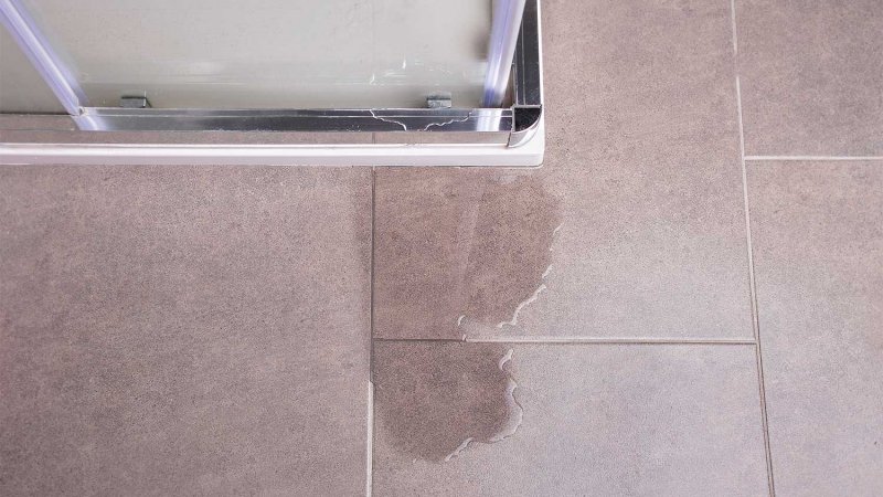 detail of a shower leak on tile floor (Photo by cunaplus - stock.adobe.com)